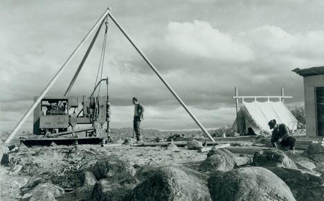 Diamond drillers at work in the Snowy Mountains, tent in background